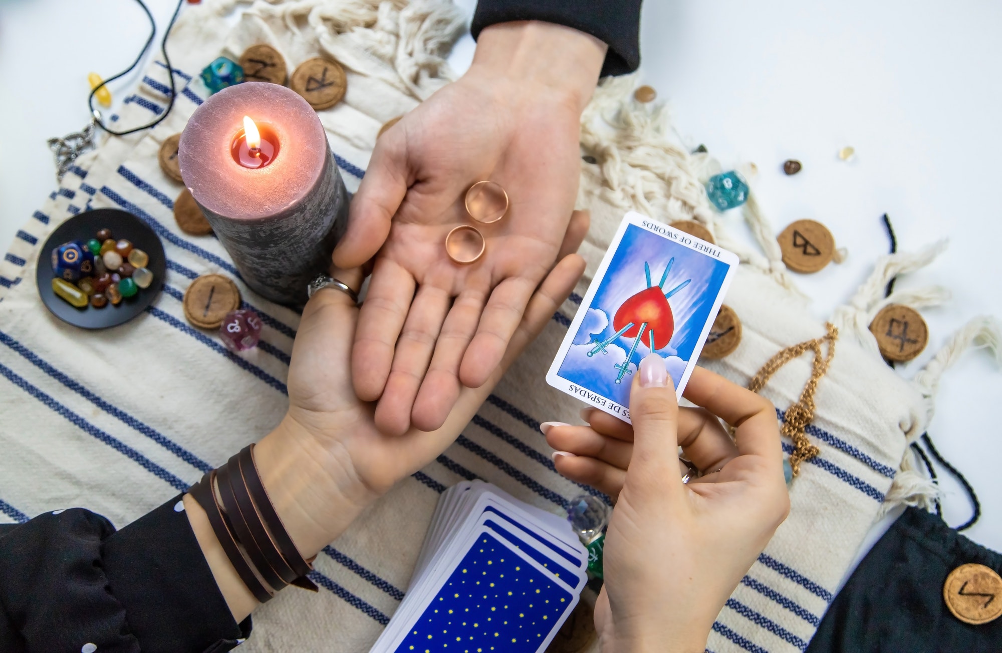 A woman fortuneteller tells a man on tarot cards. Selective focus.