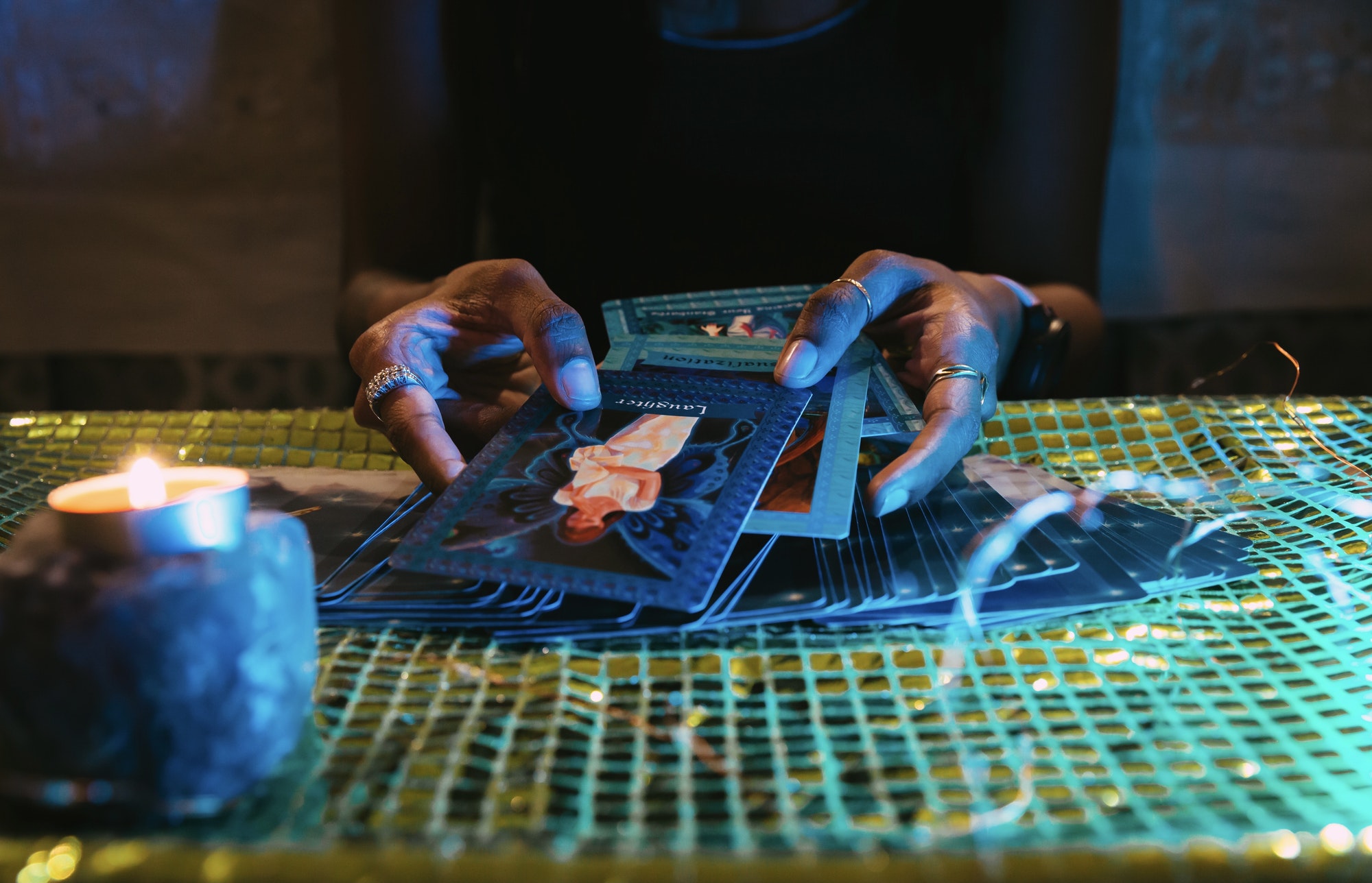 A woman’s hands picking out cards for an oracle card session