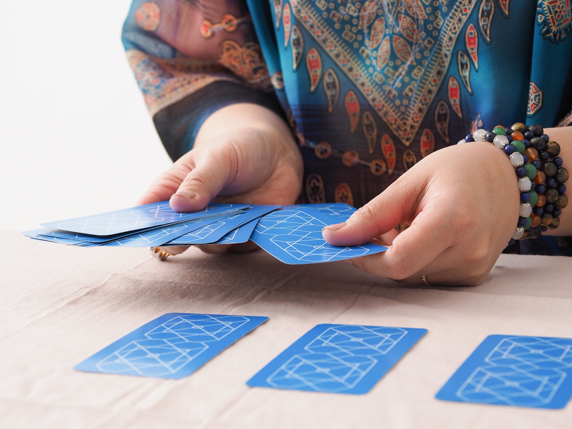 Asian woman choosing cards in tarot reading