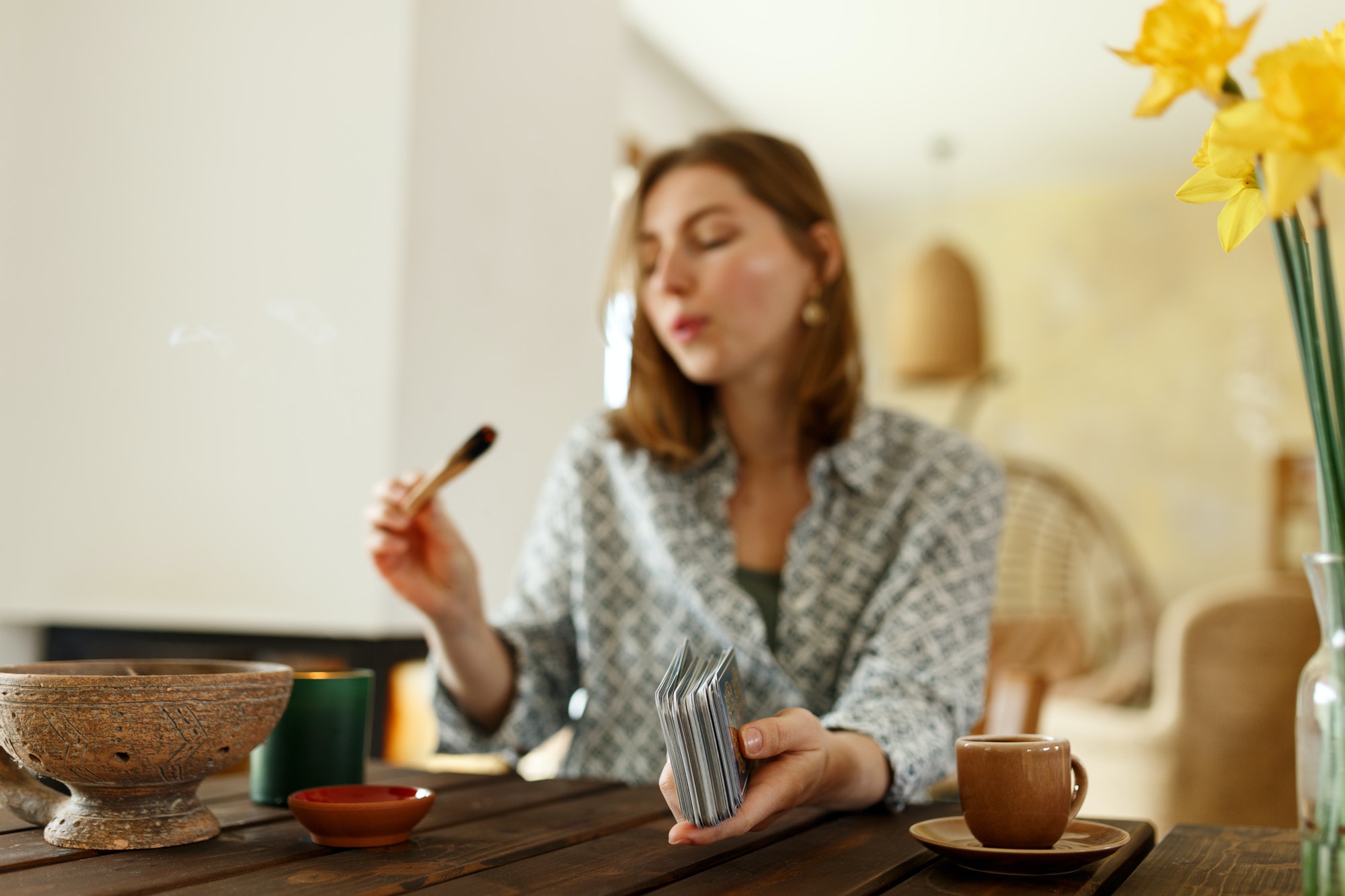 Tarot cards, Fortune telling on tarot, holding palo santo stick.