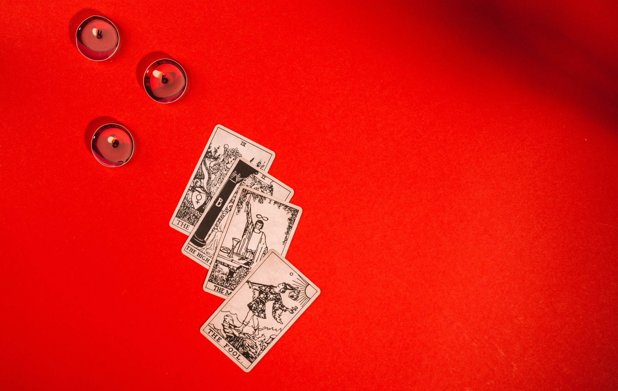 Tarot cards on red background, occult and magic
